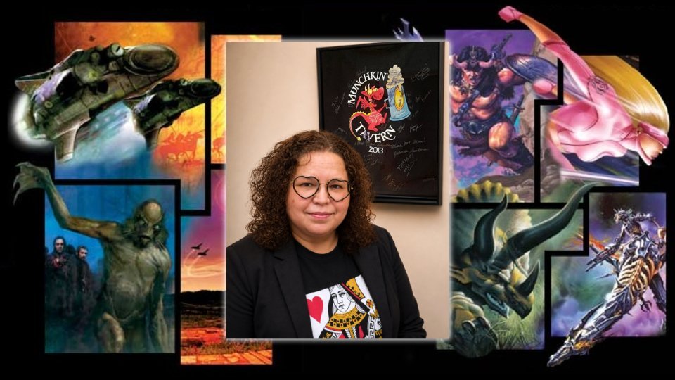 Sabrina Gonzalez diante de artes de GURPS após assumir a direção da Steve Jackson Games